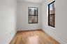 Spare room with light wood finished floors, healthy amount of natural light, and a view of city