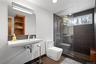Bathroom featuring walk in shower and tile patterned flooring