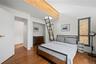 Bedroom with wood finished floors and baseboards