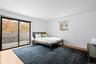 Bedroom with wood finished floors and access to outside