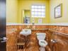 Bathroom featuring tile walls and wainscoting