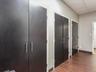 Hallway with dark wood-style flooring and baseboards