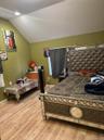 Bedroom featuring lofted ceiling and light wood-type flooring
