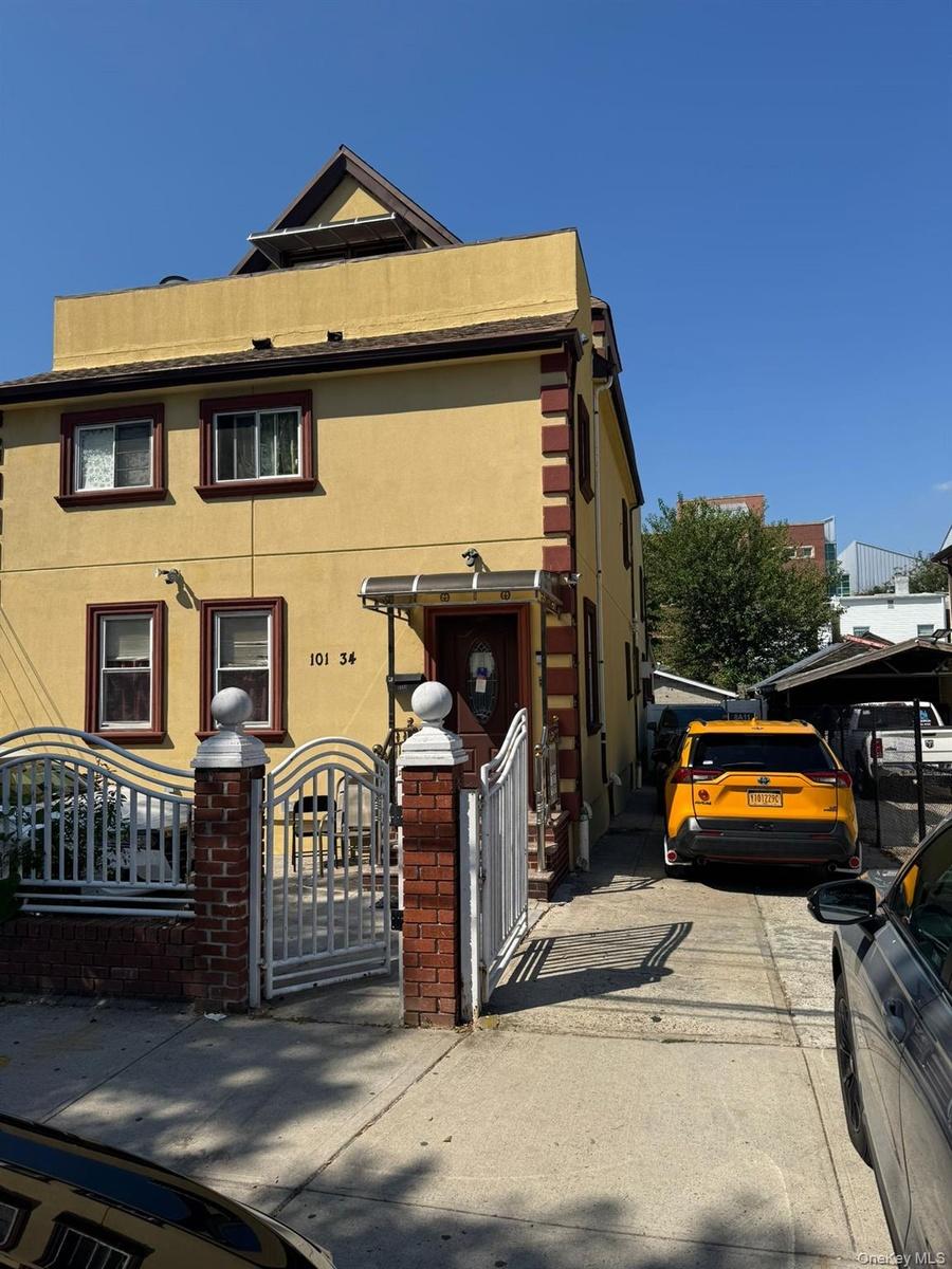 View of front of property featuring a gate and stucco siding