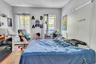 Bedroom featuring a baseboard radiator, a textured ceiling, and wood finished floors