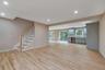 Unfurnished living room featuring recessed lighting, stairs, and light wood finished floors