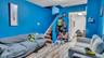 Living area featuring stairway, a textured ceiling, and wood finished floors
