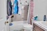 Full bathroom with vanity, toilet, and shower / tub combo