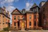 Victorian home with brick siding