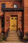 View of exterior entry featuring brick siding