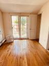 Entryway featuring a baseboard heating unit, wood finished floors, and vaulted ceiling
