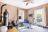 Exercise area with a ceiling fan and wood finished floors