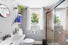 Bathroom with a shower stall and plenty of natural light