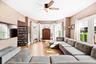 Living area with healthy amount of natural light, light wood-style flooring, and ceiling fan