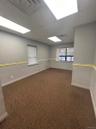Spare room with dark colored carpet and a drop ceiling