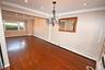Unfurnished room featuring dark wood finished floors, a baseboard heating unit, crown molding, recessed lighting, and a chandelier