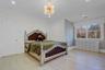 Bedroom featuring recessed lighting, light wood-type flooring, crown molding, and a chandelier