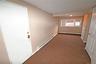 Corridor featuring a baseboard heating unit and carpet floors