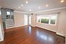 Unfurnished living room with stairs, ornamental molding, recessed lighting, dark wood-style flooring, and a baseboard heating unit