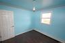 Empty room featuring a baseboard radiator, crown molding, and dark wood-style flooring