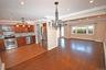 Kitchen featuring ornamental molding, appliances with stainless steel finishes, decorative light fixtures, dark wood-style floors, and a chandelier