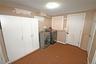 Laundry area featuring dark carpet and washing machine and clothes dryer