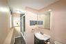 Bathroom featuring dark tile patterned flooring, bath / shower combo with glass door, and vanity