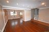 Unfurnished living room with ornamental molding, recessed lighting, stairway, wood-type flooring, and a wall unit AC