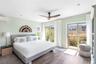 Bedroom with wood finished floors, ceiling fan, a wall mounted air conditioner, and recessed lighting