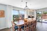 Dining room with dark wood-type flooring and baseboards