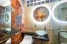 Full bath featuring tile walls, a shower stall, and tasteful backsplash