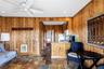 Kitchen with wooden walls, heating unit, stone tile flooring, recessed lighting, and a peninsula