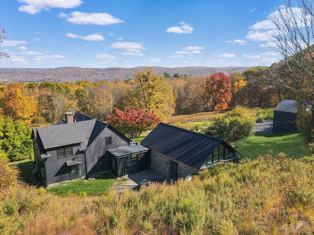 View from above of property featuring a heavily wooded area