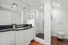 Full bathroom featuring a stall shower, dark wood-type flooring, and vanity