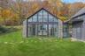 Back of property with a lawn