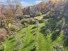 View of property location with a heavily wooded area