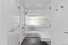 Bathroom with a stall shower, dark tile patterned floors, and recessed lighting
