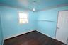 Unfurnished room with crown molding, a baseboard radiator, and dark wood-style floors