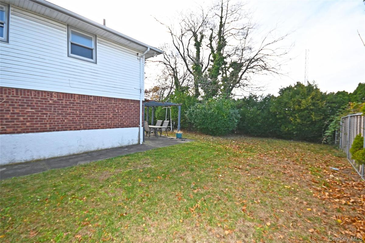 View of yard featuring a patio and a pergola