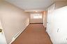 Hall with a baseboard heating unit and carpet flooring