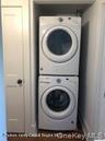 Laundry with stacked washer and clothes dryer