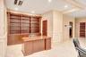 Unfurnished office featuring a decorative wall, wainscoting, recessed lighting, and light tile patterned flooring