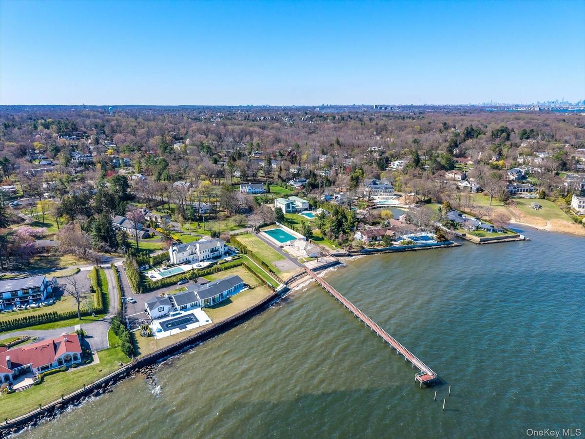 Aerial overview of property's location with nearby suburban area and a nearby body of water