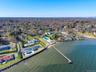 Aerial overview of property's location with nearby suburban area and a nearby body of water