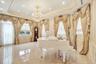 Full bath featuring a decorative wall, a raised ceiling, a chandelier, crown molding, and tile patterned floors