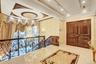 Hall featuring ornamental molding, a chandelier, a raised ceiling, recessed lighting, and tile patterned flooring
