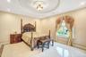 Bedroom with recessed lighting, light tile patterned flooring, crown molding, and a raised ceiling