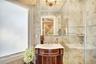 Full bath with tile walls, vanity, a shower stall, and backsplash