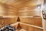 Sauna / steam room with wooden ceiling and wood walls
