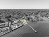 Aerial overview of property's location featuring property parcel outlined and a heavily wooded area